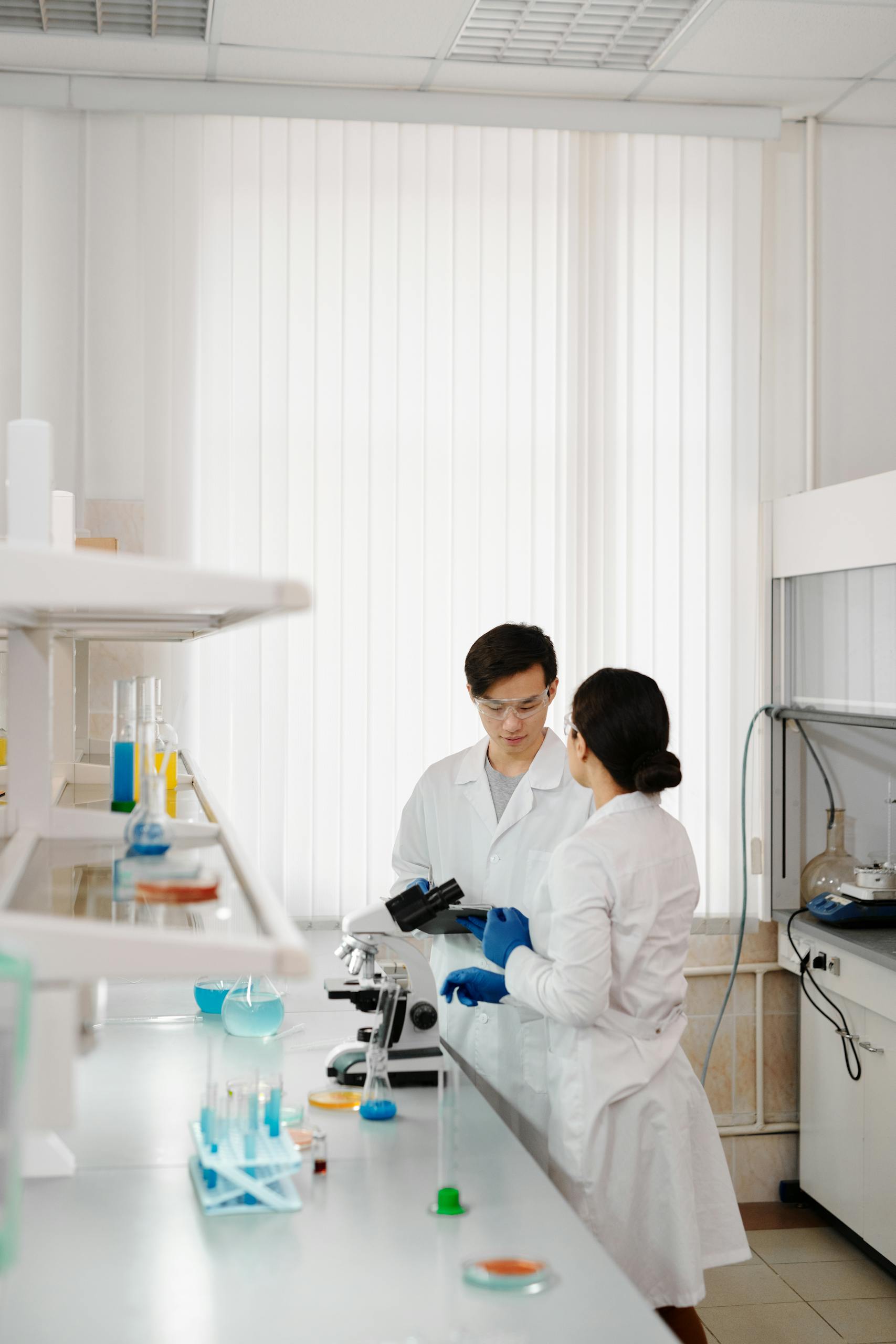 Two scientists in lab coats working in a sophisticated laboratory setting.